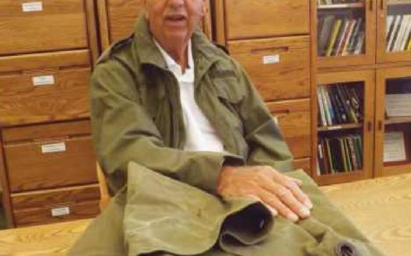 During his visit to the library, Mr. Armstrong wore his Army coat–which still fits–and brought along his faithful duffel bag.