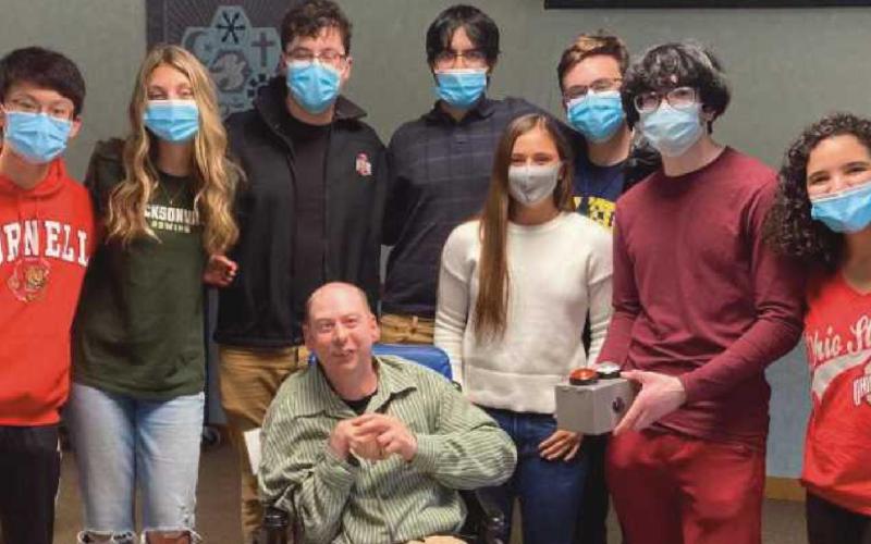 Bradley Strong, front center, with students who worked on his communication device project, from left, Tony Chen, Kennedy Rowley, Adam Roberts, Nabeel Arif, Jillian Speer, Gavin Shine, Nabeel Khatri and Julia Koehler.