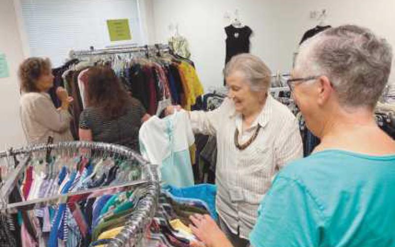 Volunteers arrange items at the Clothesline, a free clothing store offered through the Timothy’s Perrysburg Foundation.