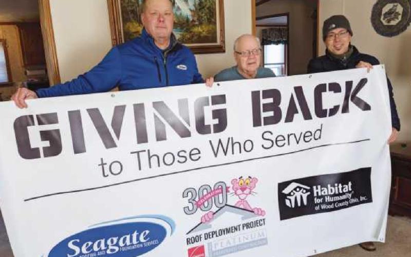 U.S. Air Force veteran Don Bylow, middle, received a new roof through Owens Corning’s National Roof Deployment Project. With him are Steve Naylor from Seagate Roofing, left, and Mark Ohashi from Habitat for Humanity of Wood County.
