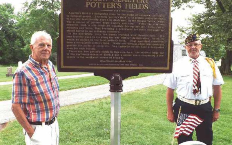 Gary Franks, left, and Craig Gauger with the Potter’s Field memorial.