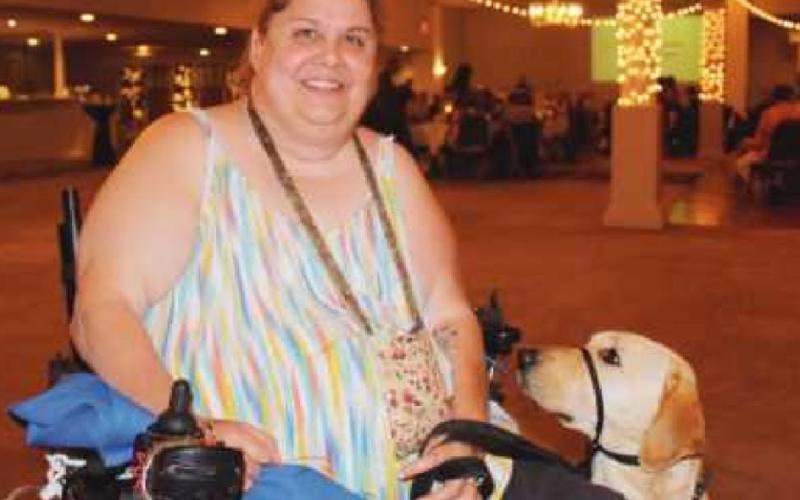 Kim Feehan of Stryker received her service dog, Cairo, in November. She and Cairo were part of the 2021 graduation ceremony because the pandemic prevented a celebration last year. “Cairo has made such a difference in my life,” Ms. Feehan said. I’m a lot more independent now. He loves his job.”