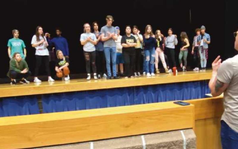 Bottom: Choreographer Dr. Clark Ausloos rehearses with the full company.