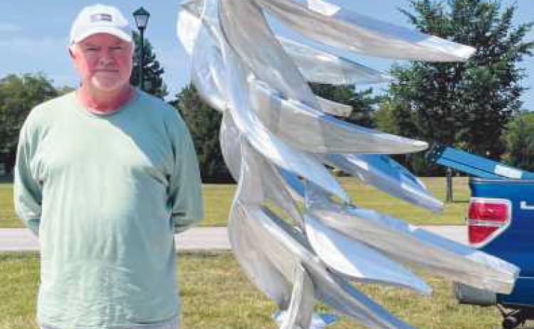 Artist Michael Young with his sculpture Quantum Flock.