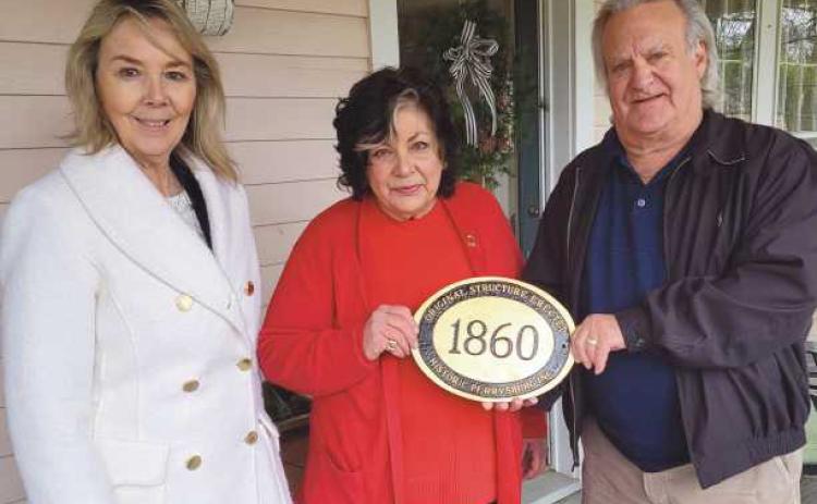 Diane Rogers, of the Guest House, 120/122 West Louisiana Avenue, recently received a historic marker from Historic Perrysburg Inc. Pictured are, from left: Joy Studer, Ms. Rogers and Dave Kleeberger. The home was built in 1860.