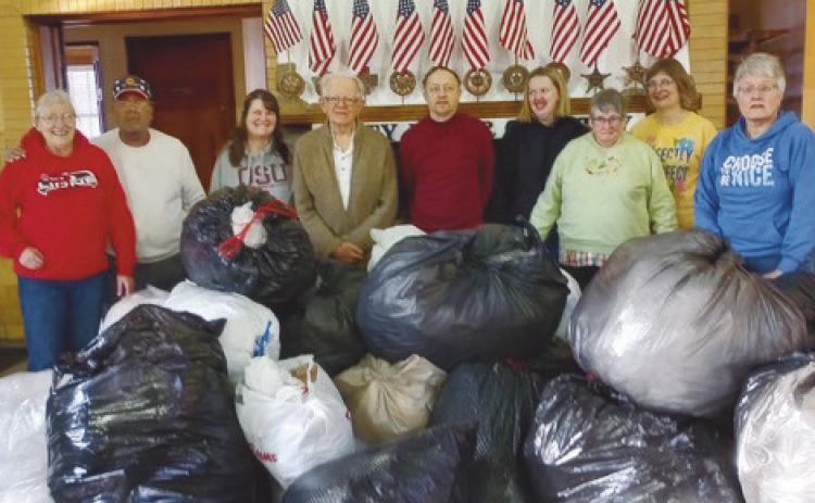 In January, the Perrysburg Lions Club members, along with Maumee United Methodist Church Awesome God class participants and leaders, pictured at left, gathered to sort and recycle plastic. At right, club