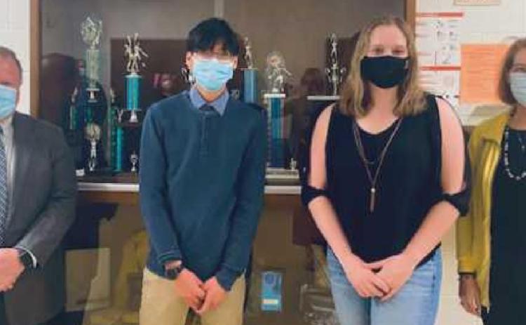PHS Class of 2021 valedictorian and National Merit Commended Scholar Evan Leong, and salutatorian and National Merit Finalist Hope Neal with school board members Eric Benington and Sue Larimer.