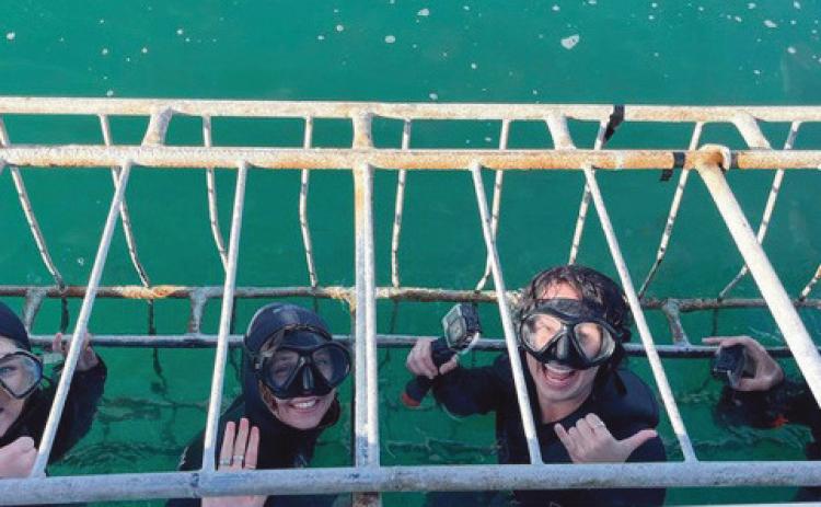 Taylor Eppard, far left, joins fellow interns for a cage diving experience to perform research on sharks.