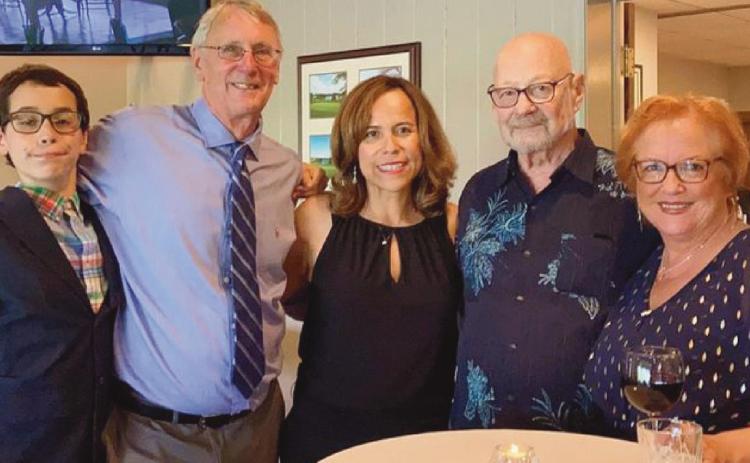 With Lorena Gloden, center, last July at the chapter meeting where she was named president of Rotary Club of Perrysburg, are, from left, her son Sebastian, her husband Dan, and her host parents Duane and Debbie Chappuies.