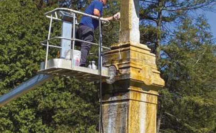 Volunteers help shine up St. Rose cemetery monument