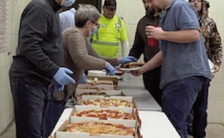 Members of the City of Perrysburg’s public service crew enjoy the gift of pizza from Julie Spann Johnson of State Farm Insurance.
