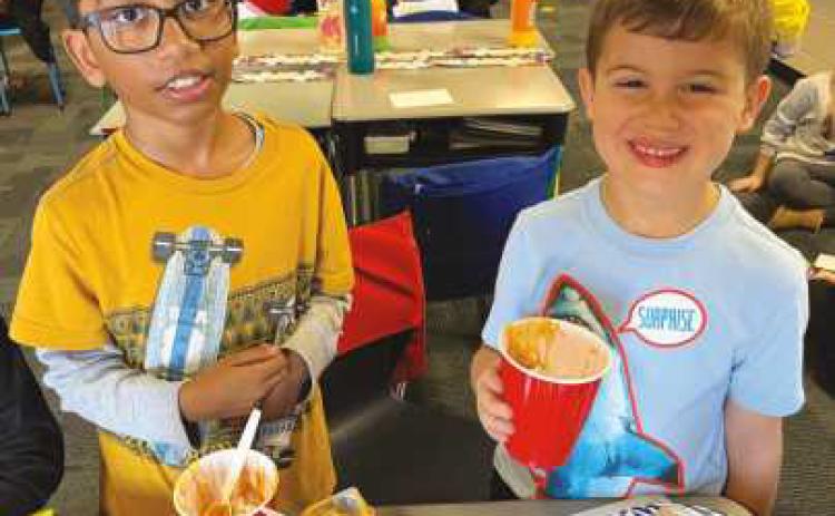 Elementary students prepare pumpkin pie in a cup