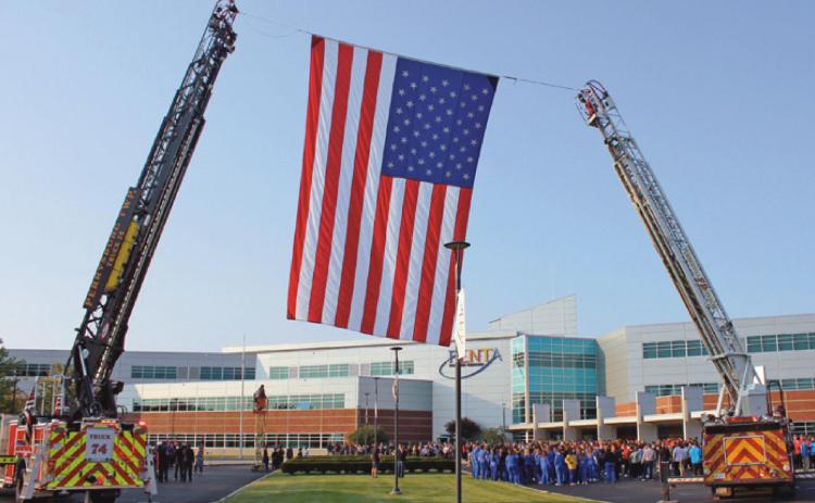 Perrysburg Township and Pemberville fire departments raise the American flag prior to the ceremony at Penta Career Center.