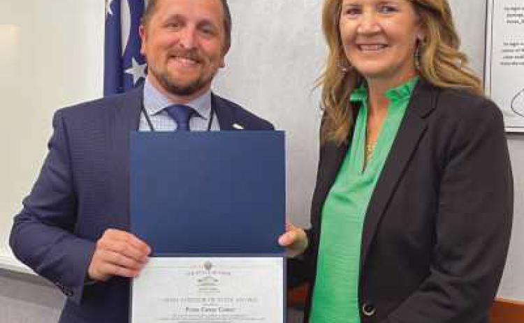 Penta Treasurer Mike Harrigan, left, accepts a perfect audit award from Lori Brodie of the auditor of state’s office for excellence in financial reporting last year. Harrigan credited retired treasurer Carrie Herringshaw, who served as treasurer at the time of the audit.