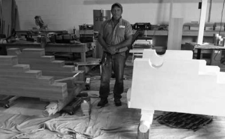 City carpenter Craig Hufford stands between the two carriages that will hold the cannons.