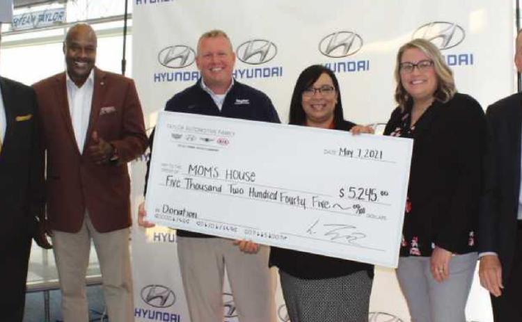 From left: Tom Cole, community outreach coordinator, and Terry Crosby, outreach community ambassador for Taylor Automotive; Steve Taylor, general manager; Christina Rodriguez, executive director, Julie Haas, program manager, and Mike Kruse, board president for Momʼs House.