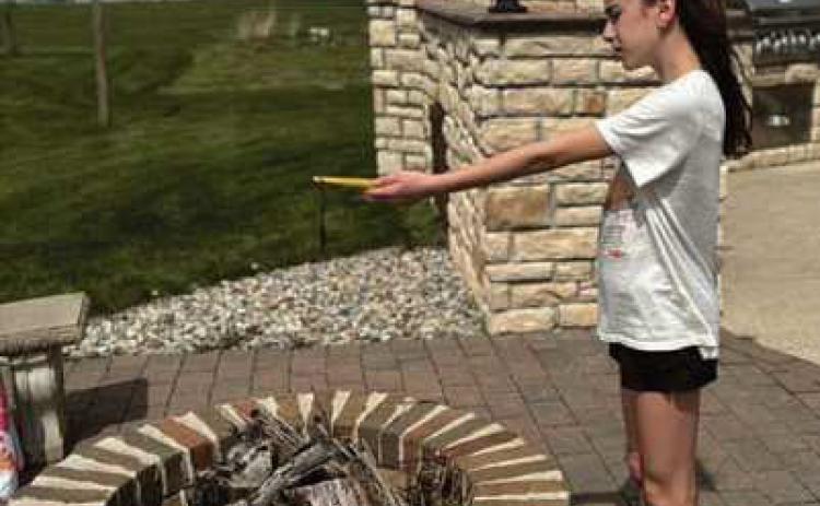 Lilian Barkholz, sixth grade student at HPI, uses a digital thermometer to collect air temperature data during the April 8 solar eclipse. The data was submitted to the NASA GLOBE program as part of a citizen science project.