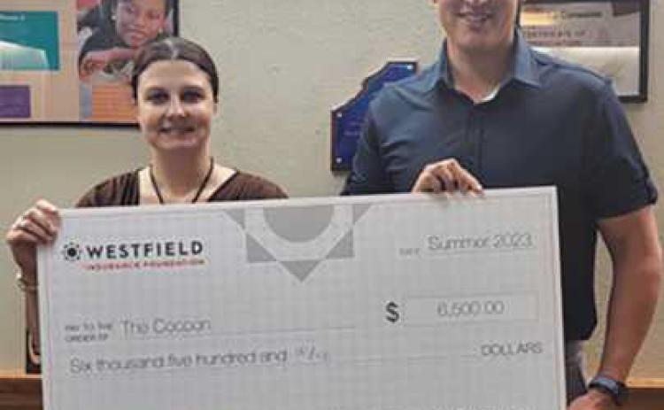 Kathy Mull, left, executive director of the Cocoon, with First Insurance Group agent, Matt Karaffa, right.