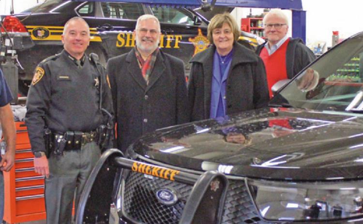 The new sheriff’s vehicles are being prepped before patrolling Wood County roads. Above from left are Chris Heinz, county garage supervisor; Sheriff Mark Wasylyshyn, and county commissioners Craig LaHote, Doris Herringshaw and Ted Bowlus.