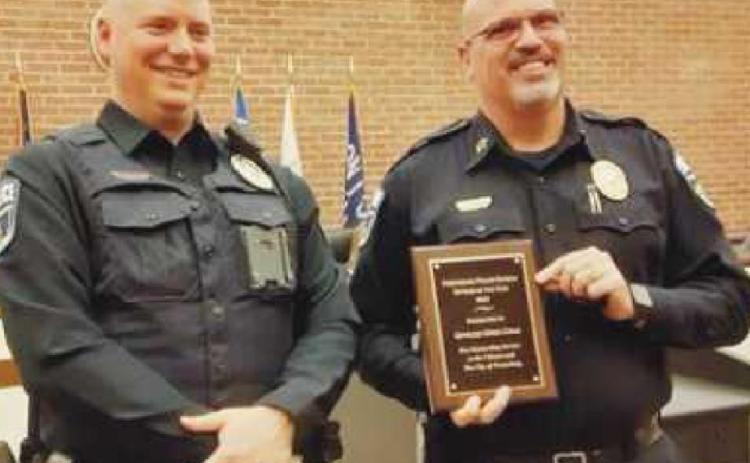 Chief Patrick Jones, right, presents Officer Greg Cole with the Officer of the Year award. Officer Cole is the school resource officer for Perrysburg High School.