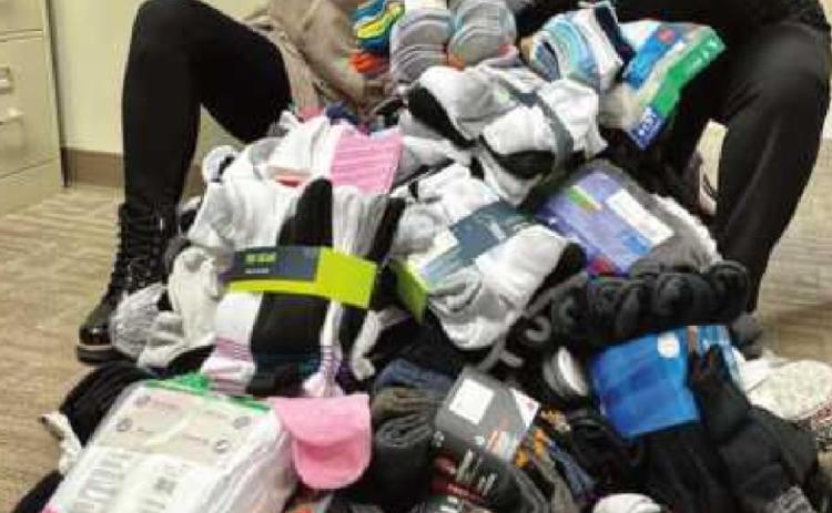 Sarah Bucher and Jordan Beach pictured with some of the sock donations.