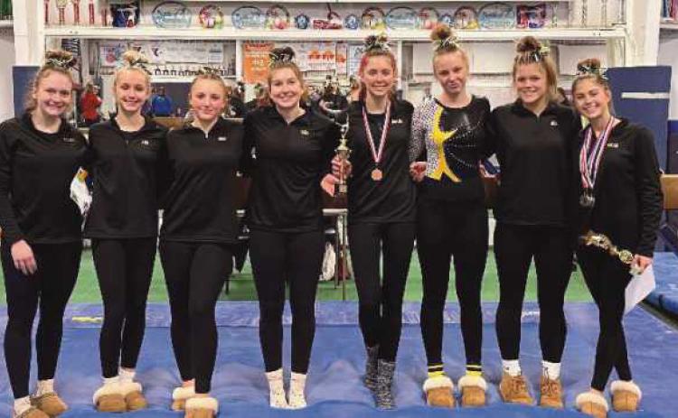 The varsity gymnasts, pictured above and below, took first place at the event to raise awareness for Duchenne Muscular Dystrophy.