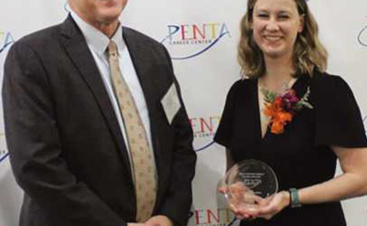 Perrysburg Superintendent Tom Hosler congratulates Alyssa Basham Johnson, a PHS Class of 2013 student, who was enrolled in Penta’s culinary arts program.