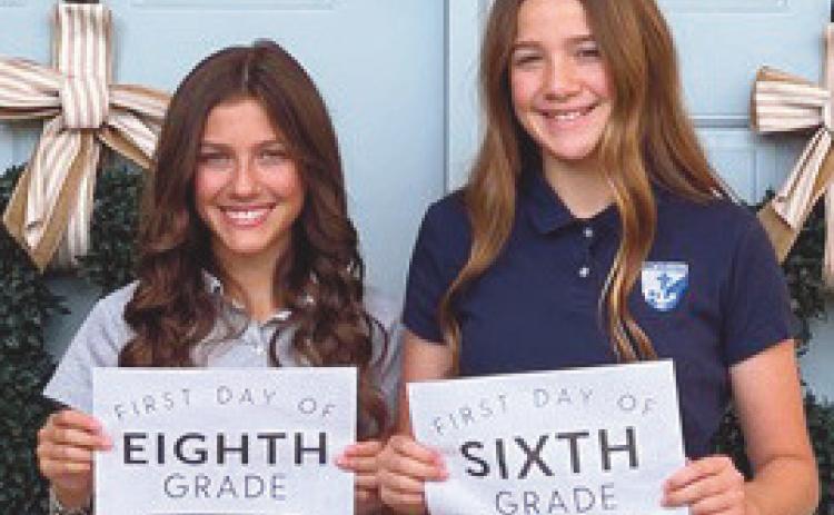At left, eighth grader Kopelyn Kessler and sixth grader Kieradyn Kessler prepare to return to St. Rose.