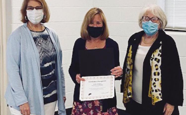 School board members Sue Larimer, left, and Gretchen Downs, right, with Debbie Reddic, who was honored as the district’s Shining Star for spring 2021.