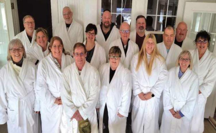 Pictured at right: A tradition at the Carriage House is to take a group photo of guests wearing the robes provided by the bed and breakfast. Pictured are, front row, from left: Phyllis Zibbel, Michelle Abel, Robin Abel, Amy Gross, Loriann Czerniejewski and Darcy Ulrich. Middle row: Vickie Pawlowski, Lucia Rooks, Howie Zibbel, Frank Czerniejewski and Jan Leutz. Back row: Jeff Ulrich, Don Leutz, Dave Pawlowski, Keith Rooks and Clark Gross.