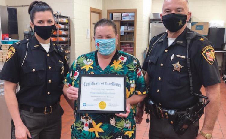 Captain Rebecca McMonigal, food service coordinator Sandy Snow and Wood County Sheriff Mark Wasylyshyn.