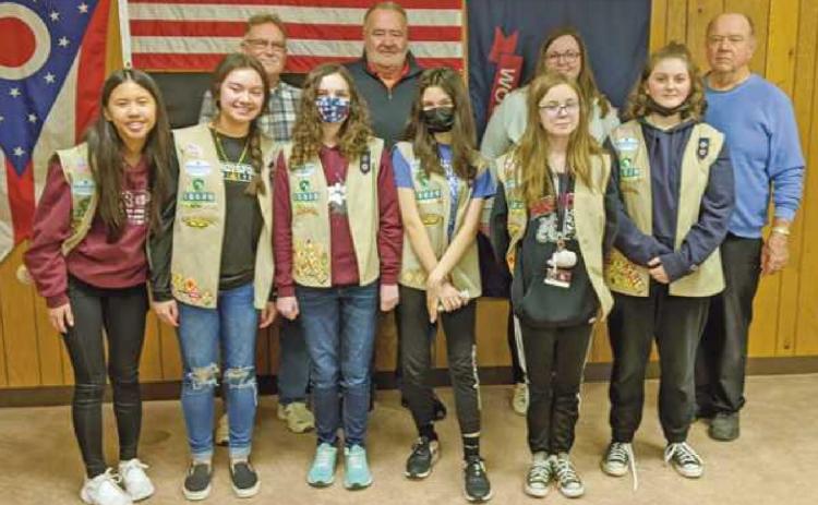 With members of Girl Scout Troop 10020, are, in the back row, Trustees Gary Britten and Joe Schaller, fiscal officer Hannah Nelson and recreation director Bob Warnimont. The scouts delivered cookies as an expression of gratitude to township officials for allowing them to use the facilities for delivery and distribution of cookies for their annual sale.