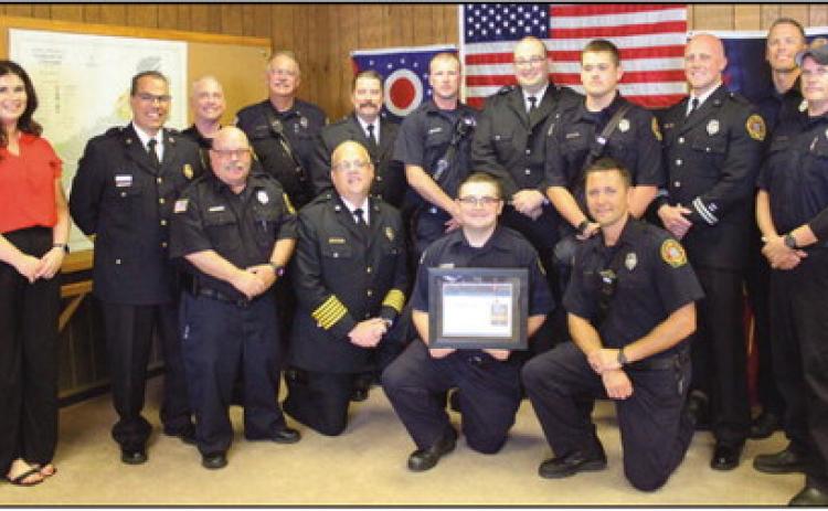 Firefighting team members display the department’s new American Heart Association award.