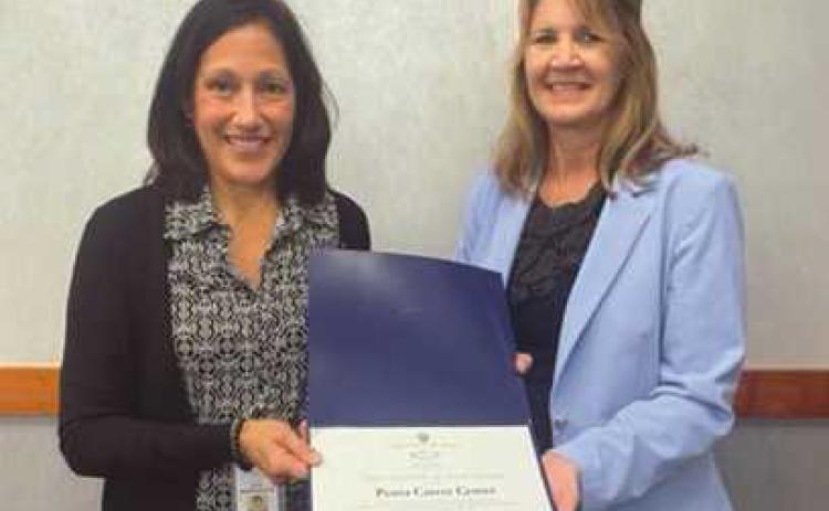 Penta Treasurer Carrie Herringshaw, left, accepts a perfect audit award from Lori Brodie of the auditor of state’s office.