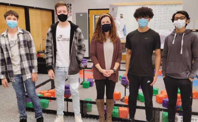 Instructor Lexi Marshall, center, in the STEM classroom with some of her students. “I never get bored,” she said. “Every day is different.”