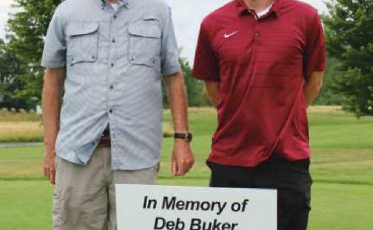 The 10th hole was dedicated to former Perrysburg Messenger Journal editor Deb Buker, a dog lover and huge supporter of the annual event, who passed away in 2020. Above are Mrs. Buker’s husband Les and son Scott.