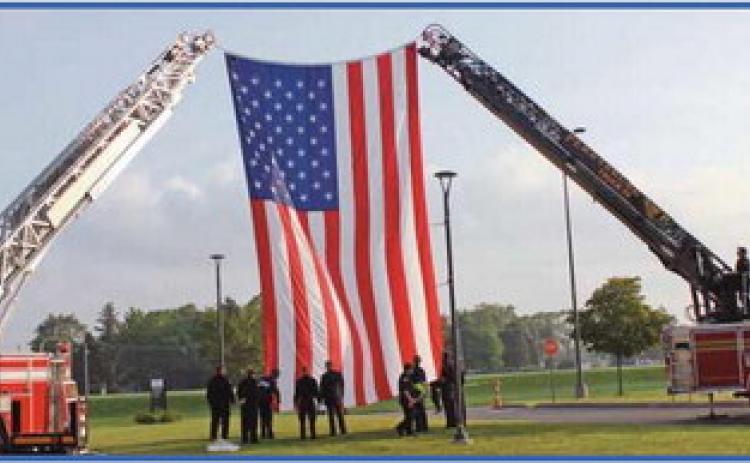 Perrysburg Township and Pemberville fire departments raise the American flag with assistance from Penta’s criminal justice students.