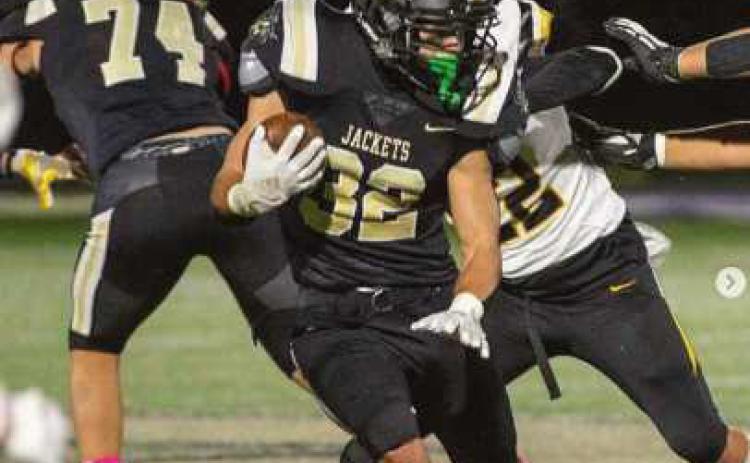 Runningback Joseph Seney scampers past the Wildcats. The Jackets wore pink socks for Breast Cancer Awareness month.