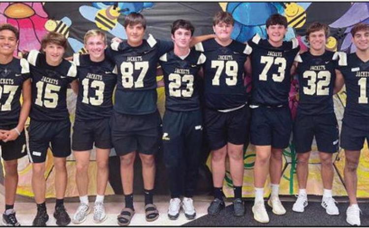 Football players visit Toth in Jacket Way program