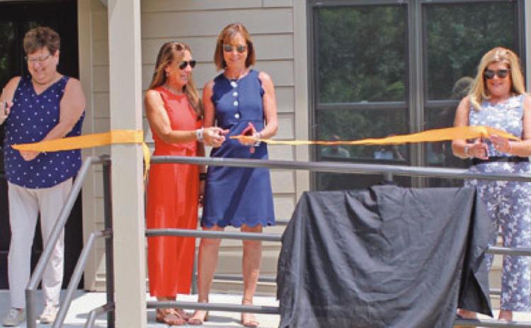 Members of the Sawyer family join Wood County Park District commissioners in dedicating the newly refurbished interpretive center at Sawyer Preserve on Lime City Road in Perrysburg Township. From left are Molly Sawyer Ludtke, park commissioner Sandy Wiechman, sisters Elizabeth Sawyer Biederman and Sally Sawyer Burns, and park commissioners Kim Rose and Tom Myers.
