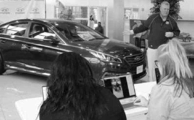 Steve Taylor with the 2015 Hyundai Sonata presented to the winner of the first Free Car Friday. With him are three Taylor employees who managed the random drawing.
