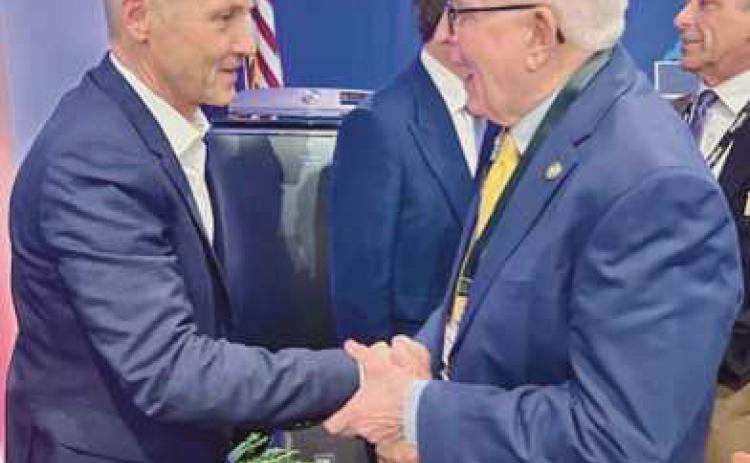 Mayor Mark Weber (right) shaking hands with Marc Bitzer (left), chairman and CEO of Whirlpool Corporation.