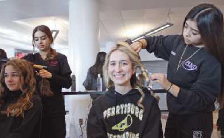 Georgia Von Deylen and Meredith Kulmatycki enjoy having their hair done at the cosmetology area.