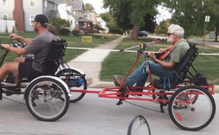 Jared Parseghian treats Bruce Brody to a ride so he can play guitar and sing.
