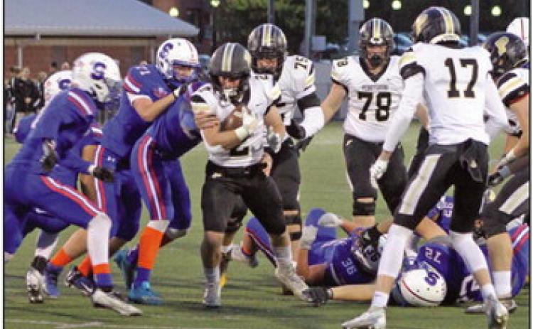 Quarterback T.J. Takats breaks through a hole up the center.