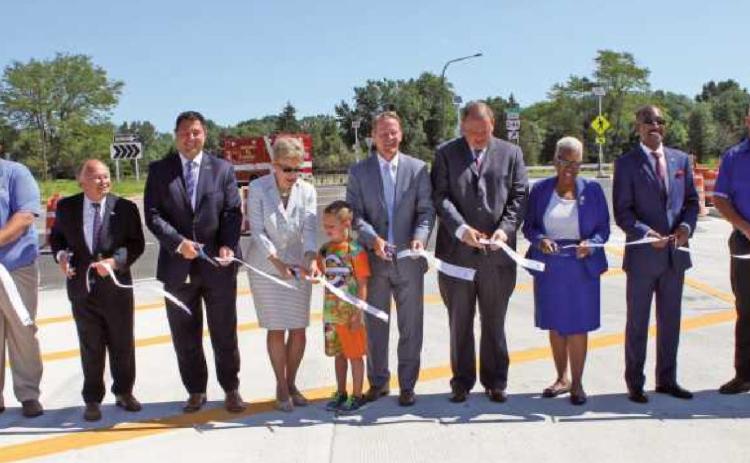 Ohio Lt. Governor Jon Husted and U.S. Congresswoman Marcy Kaptur, center, are flanked by public officials cutting the ribbon to officially open the I-475/Dorr Street interchange.