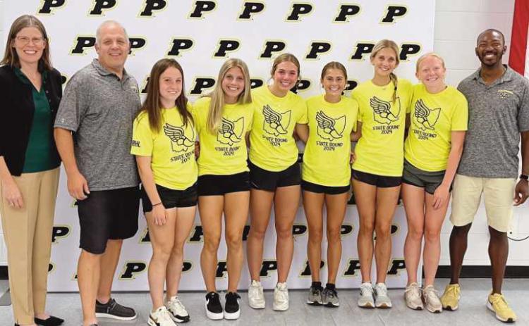 From left are board of education member Susan Rowland Miller, Coach Jon Monheim, Emma Ogdahl, Elyza Byrd, McKenna Conley, Ava Kincaid, Hannah Kersten, Natalie Sanders and Coach Darryl Edge. Team members not pictured are Camille Francis, Kinsley Jones, Ava Beeks, Laura Valette.