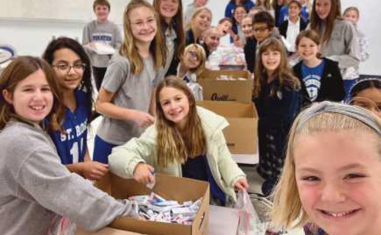 Saint Rose School recently held a supply collection drive to donate to a medical mission to Ukraine. Dr. George Namay and Dr. Brett Pelok also provided personal dental supplies. Students created inspiring cards and packaged up the supplies. More than 200 kits were made.