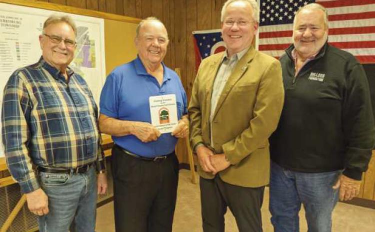 The Wood County Park District director presented the trustees with a plaque commemorating their park district grant. From left are Trustee Gary Britten, Recreation Director Bob Warnimont, who applied for the grant, and Trustees Bob Mack and Joe Schaller.