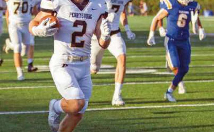 Runningback Connor Walendzak, eludes Trojan players, scooting down the sideline for six.